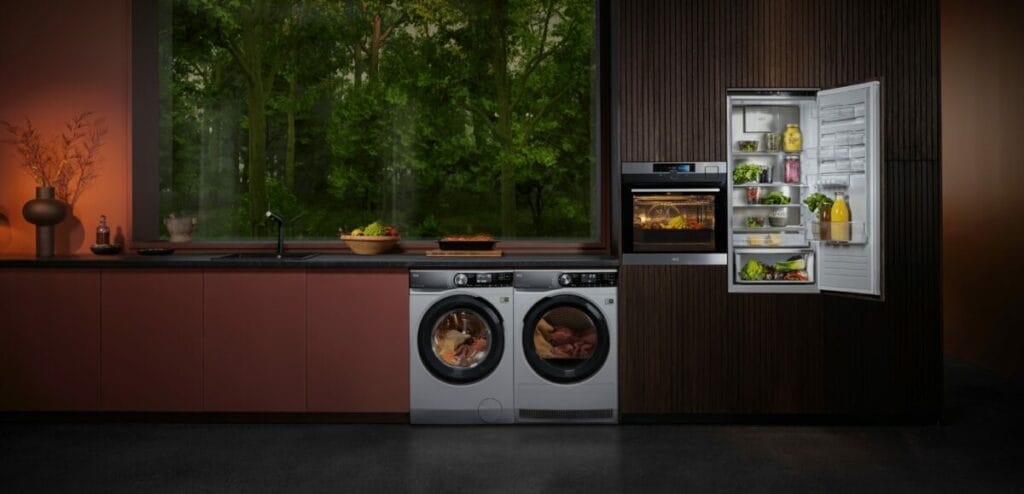 Modern kitchen with integrated AEG appliances: refrigerator, oven, washing machine and designer dryer in a contemporary interior.