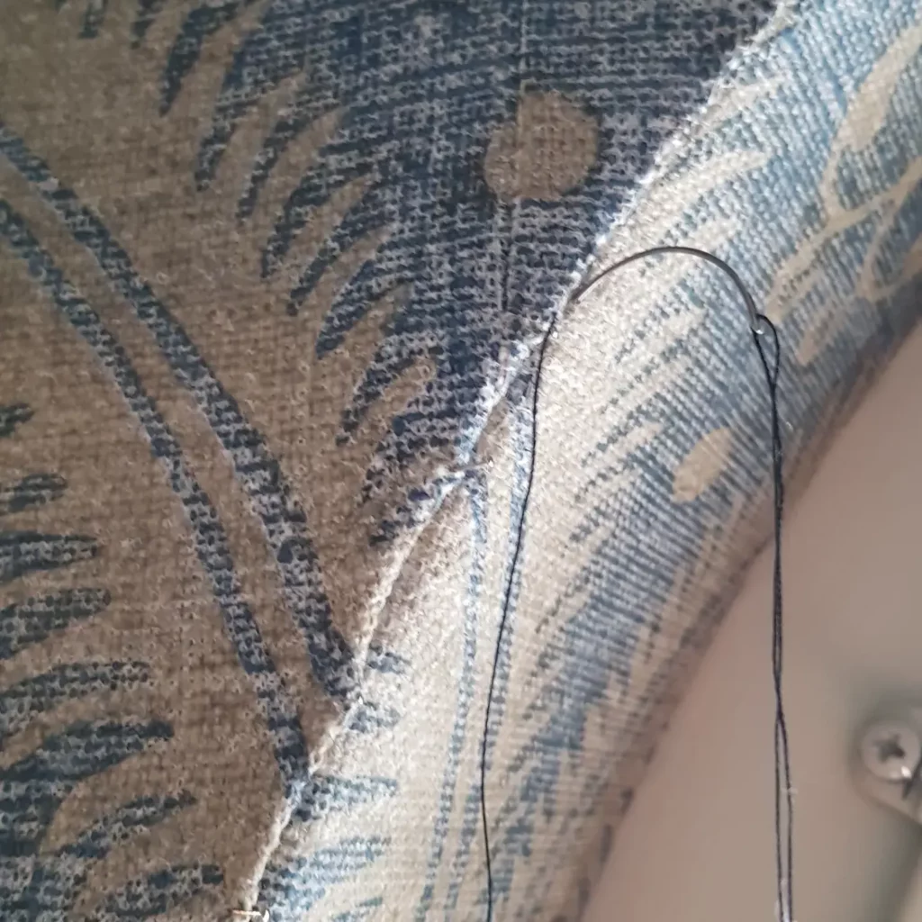 Hand stitched fabric walling detail around round window