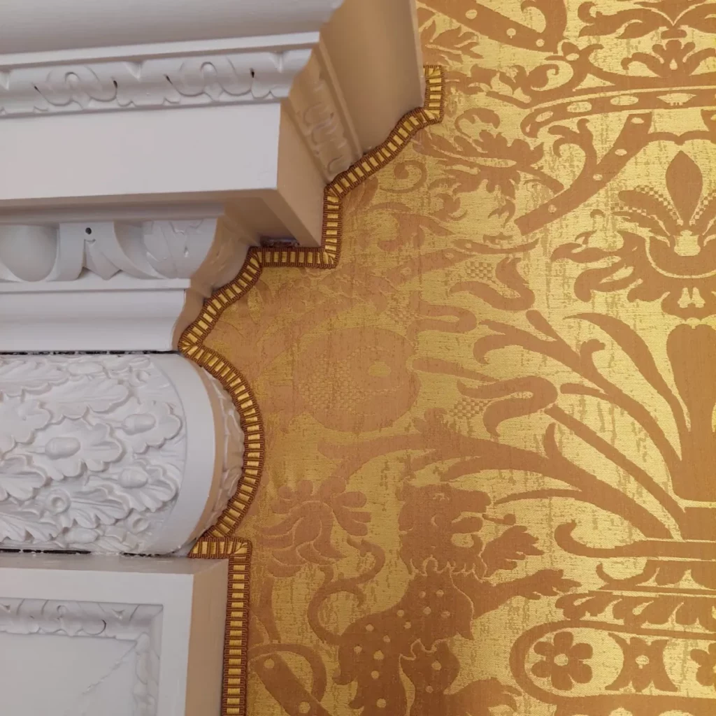 Traditional fabric walling with decorative trim and braid