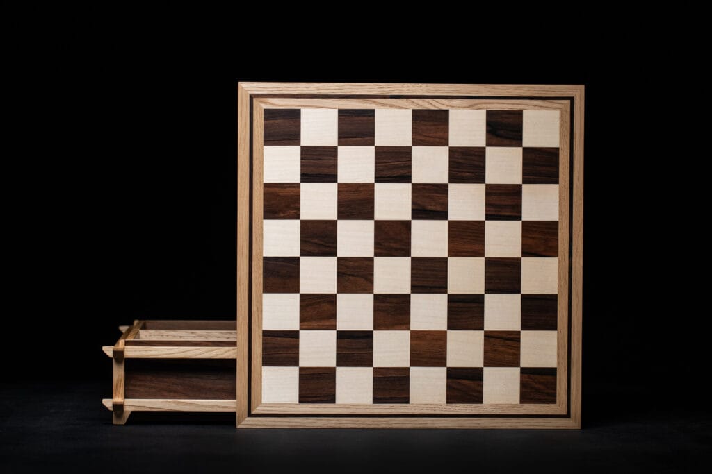 Ordalie Chessboard in solid wood designed by cabinetmaker Adrien des Rues, contemporary artisanal furniture piece associating different wood species in a graphic and architectural composition.
