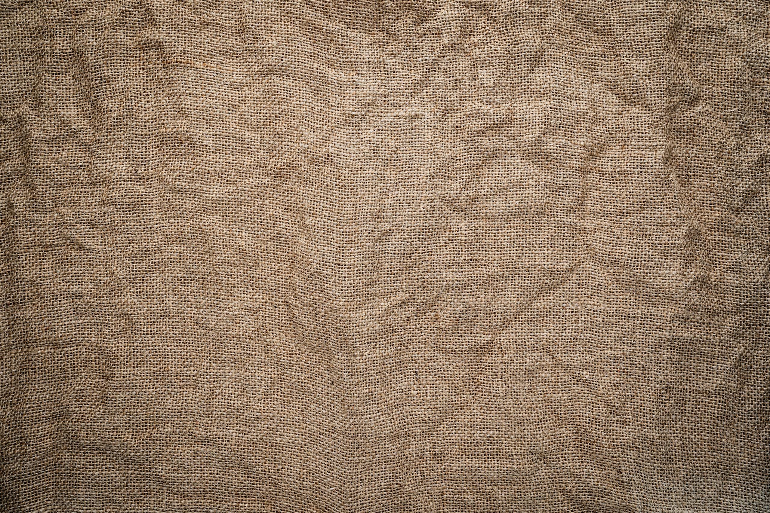 High-resolution image of crumpled burlap fabric showing detailed texture and pattern.