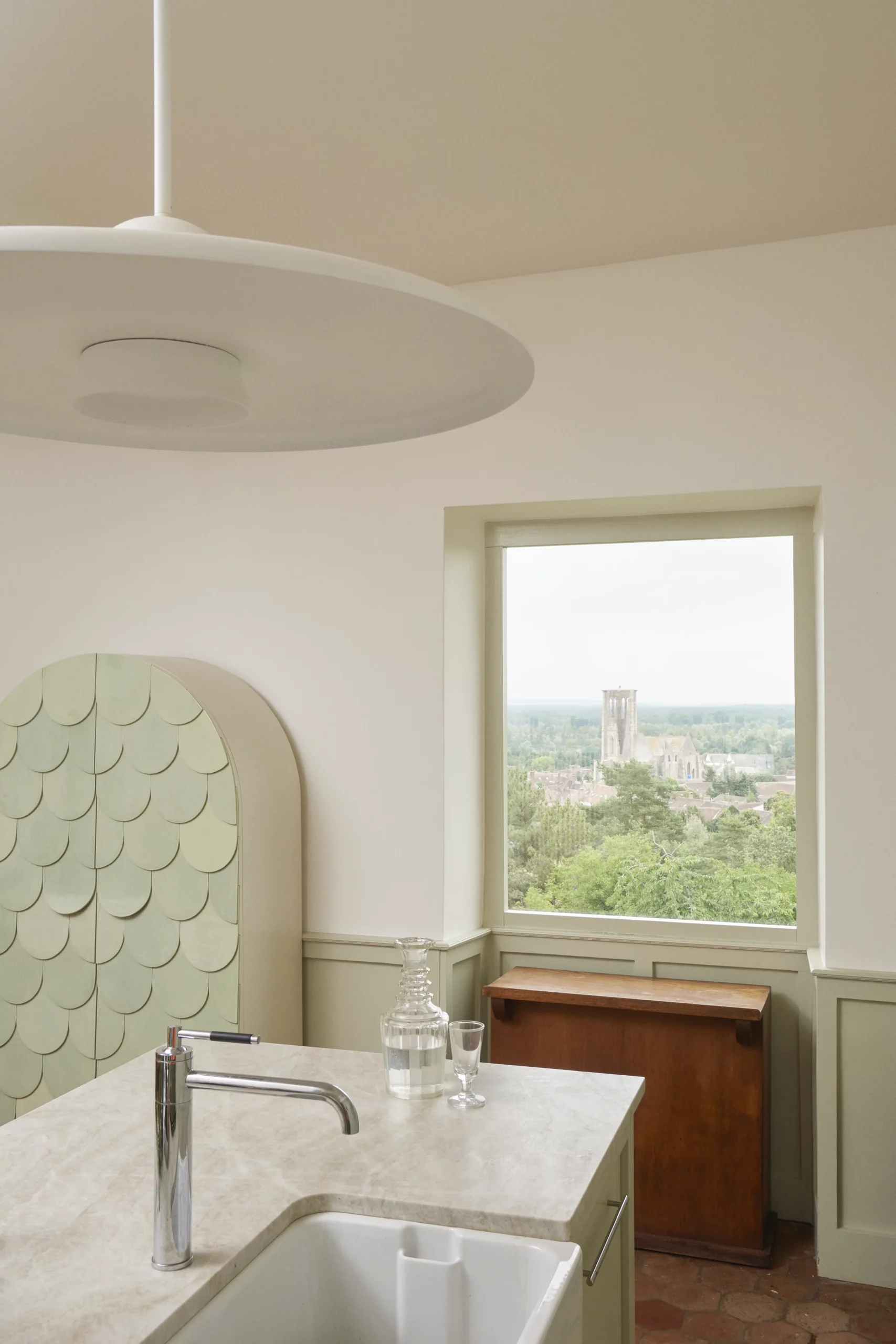 Close-up of the kitchen island in Taj Mahal stone at Le Chapitre by Eric Schmitt